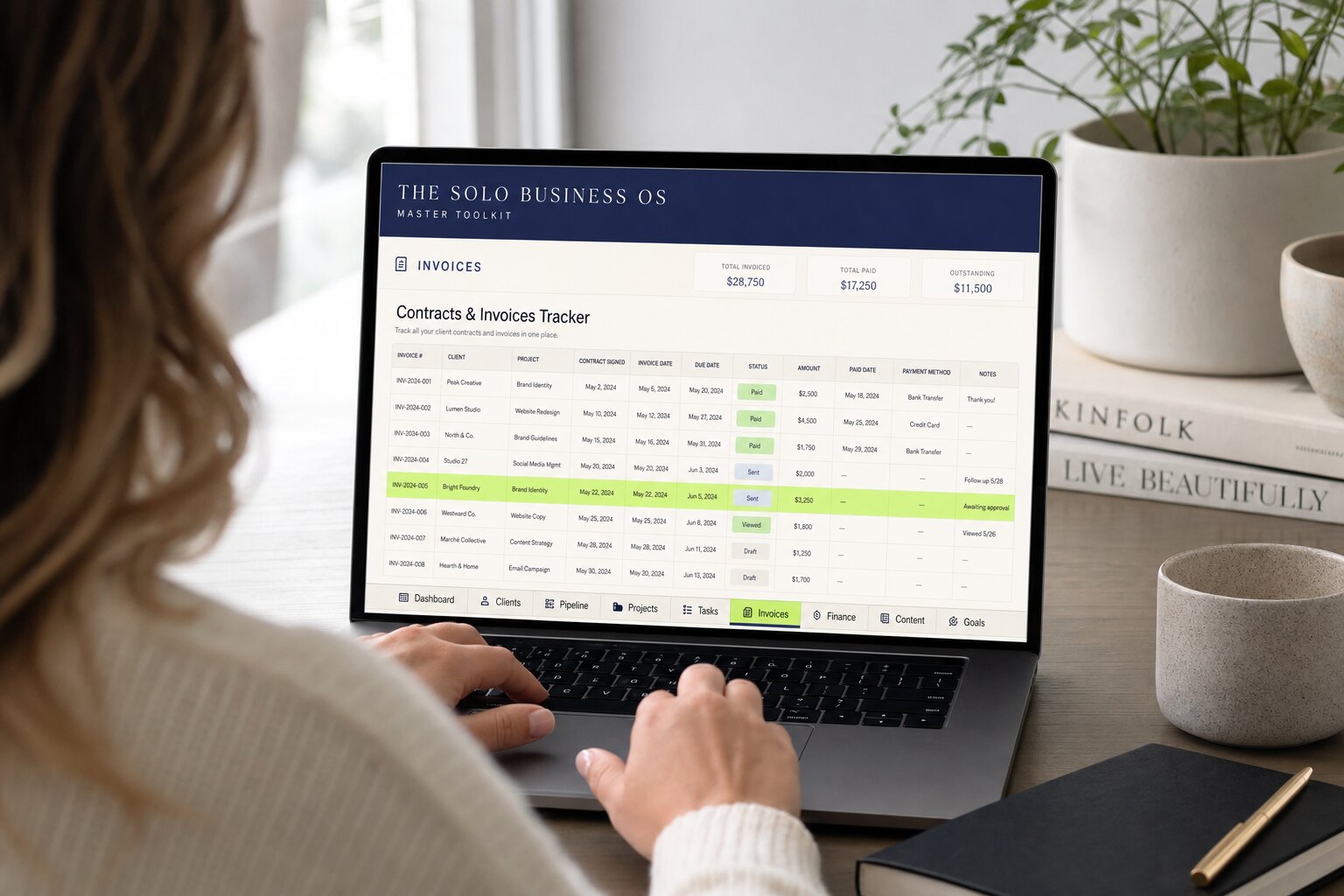 The Master Toolkit on a laptop, open to the Contracts & Invoices tab