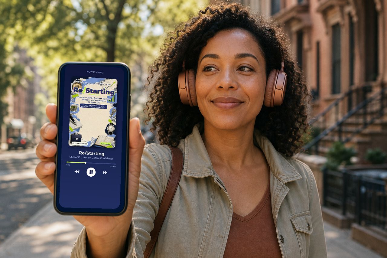 Listening to the Re/Starting audiobook with headphones, the chapter playing on a phone