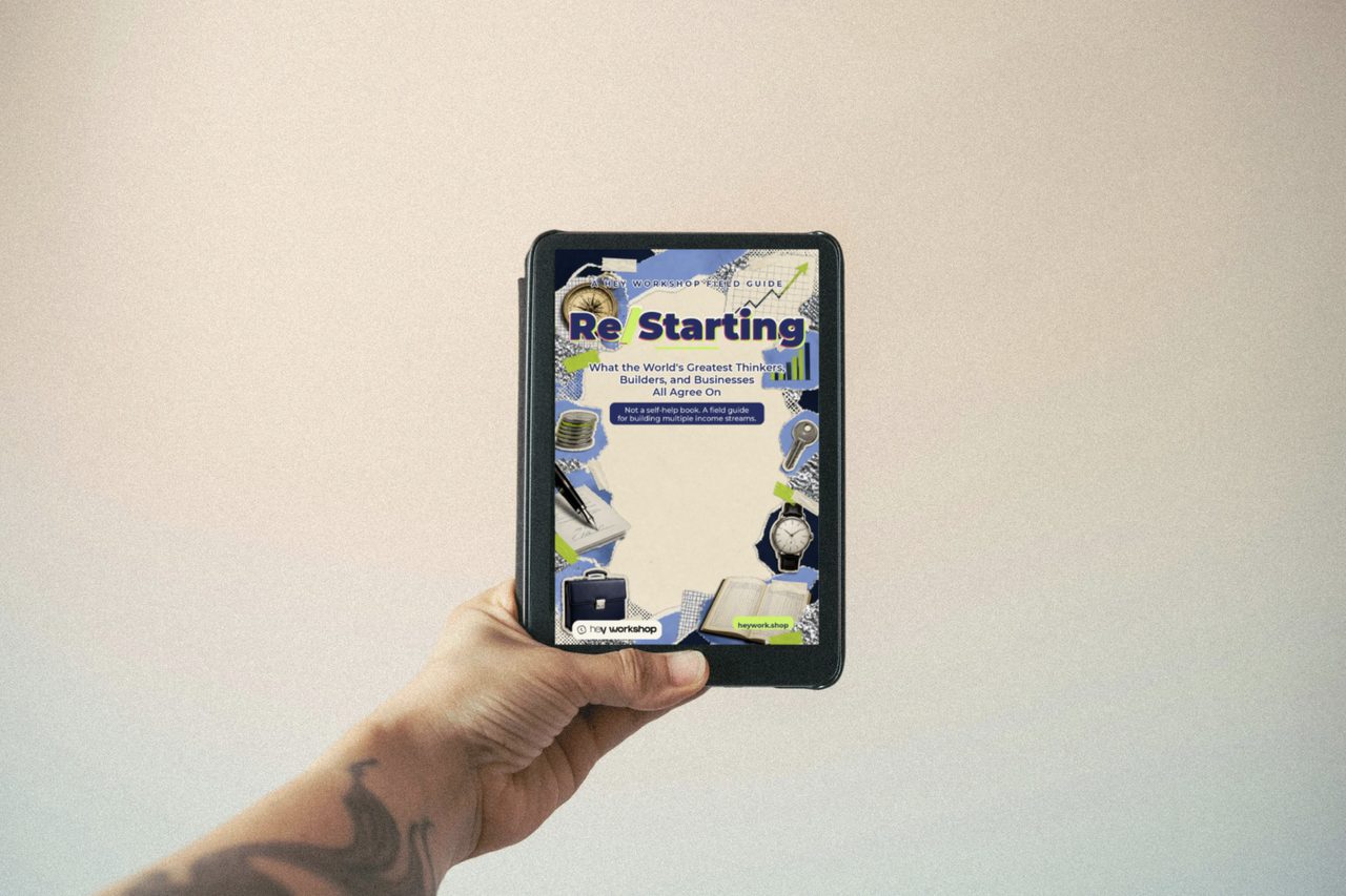 A hand holding an e-reader with the Re/Starting cover on screen